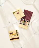 The Tiny Finch wine-themed matchbook set featuring illustrated bottle designs and decorative matchsticks.