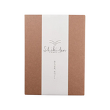 The Tiny Finch A6 Red Pine notebook featuring a natural wood grain cover with a white paper sheath and branding.