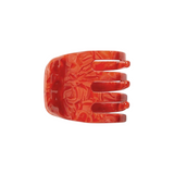 The Tiny Finch mini hair claw clip in a vibrant poppy red marbled Italian bio-acetate finish.