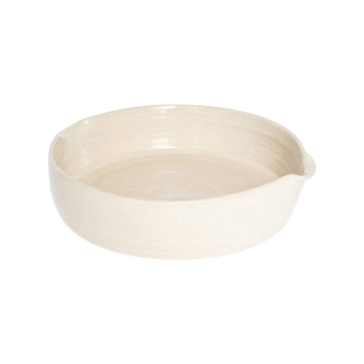 The Tiny Finch lead-free stoneware bake dish in a neutral cream finish with a simple, durable round design.