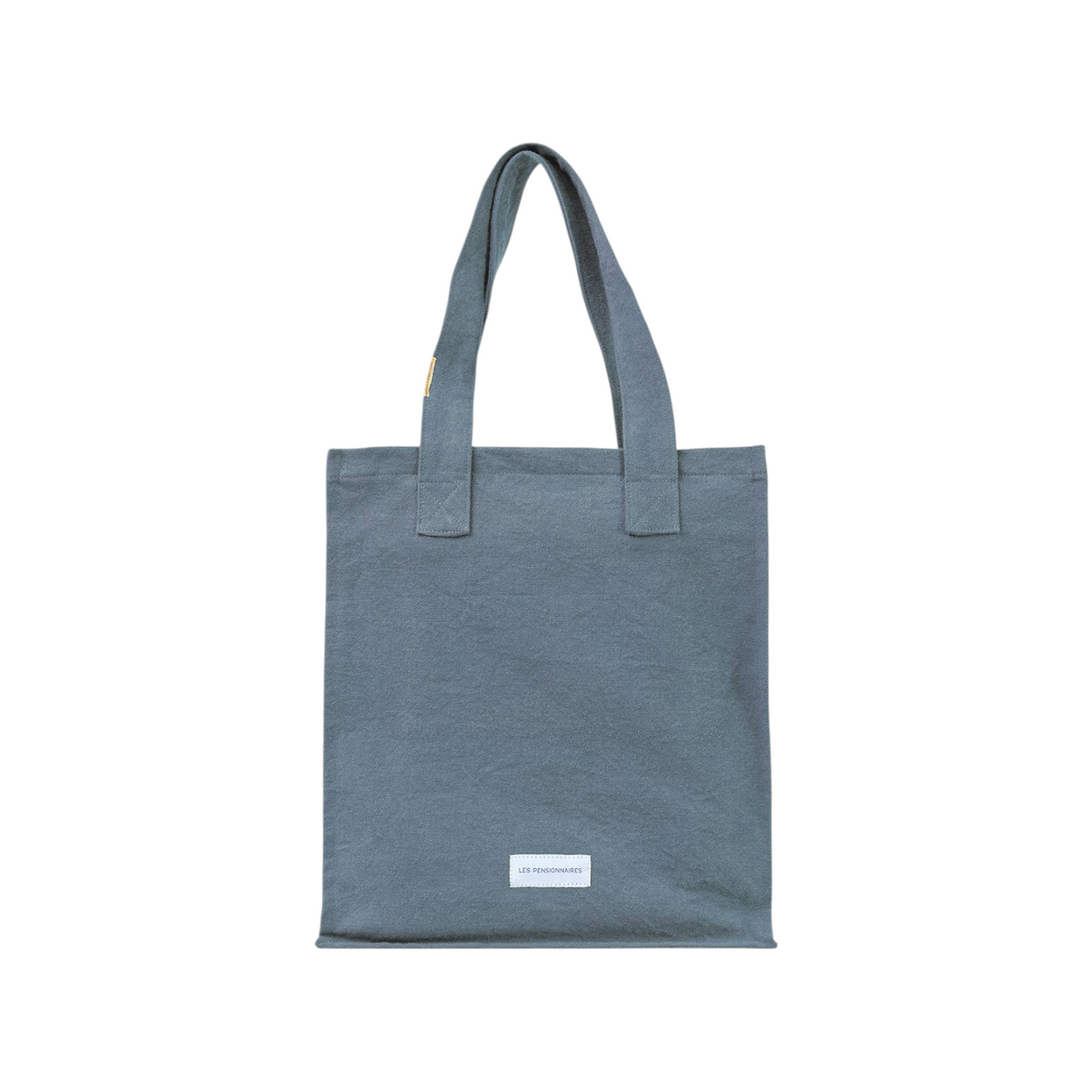 The Tiny Finch horizon blue organic cotton canvas tote bag with a secure zip closure and interior pocket.