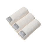 The Tiny Finch set of three white Nanoweave face towels with grey VOLO Beauty logo tags, rolled for display.