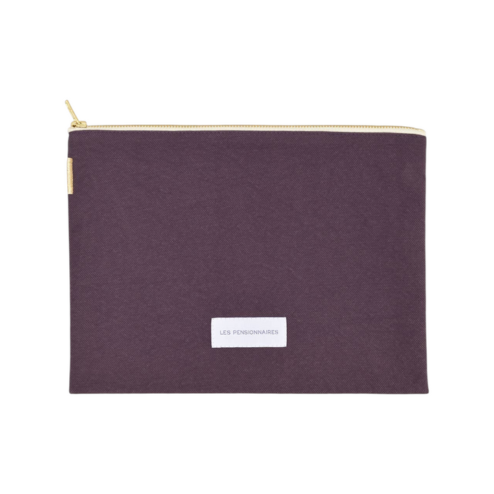 The Tiny Finch eggplant purple organic cotton canvas pouch with a gold zipper and Les Pensionnaires label.