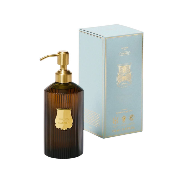 The Tiny Finch Trudon Carmen hand soap in a ribbed amber glass bottle with a gold pump and matching light blue box.