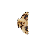 The Tiny Finch midi hair claw clip in blonde tortoise Italian acetate with a double-walled design.