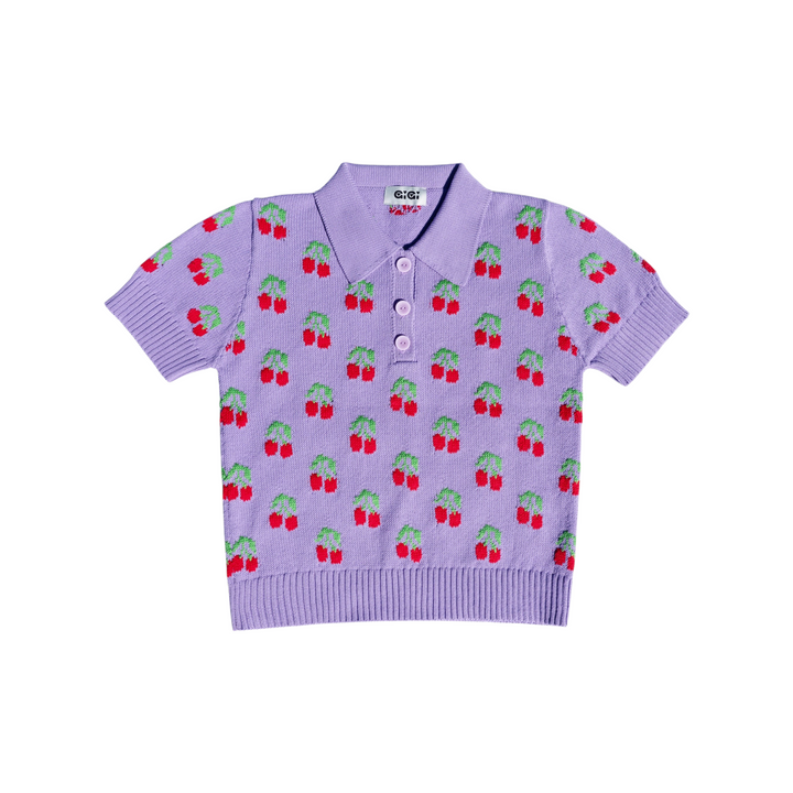The Tiny Finch violet organic cotton polo shirt featuring a playful red cherry and green leaf knit pattern.