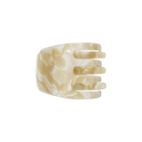The Tiny Finch handcrafted mini hair claw clip in ivory Italian bio-acetate with a marbled finish.
