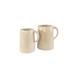 The Tiny Finch handmade stoneware pitchers in beige, featuring a simple farmhouse design for serving or decor.