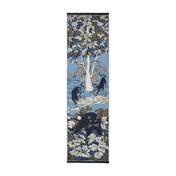 The Tiny Finch Inoui Editions cashmere and silk scarf featuring a blue panther and forest print on a light blue base.