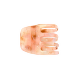 The Tiny Finch mini claw hair clip in a pink and cream marbled Italian bio-acetate finish.