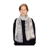 The Tiny Finch white wool scarf with blue handprinted toile de jouy design worn by a model