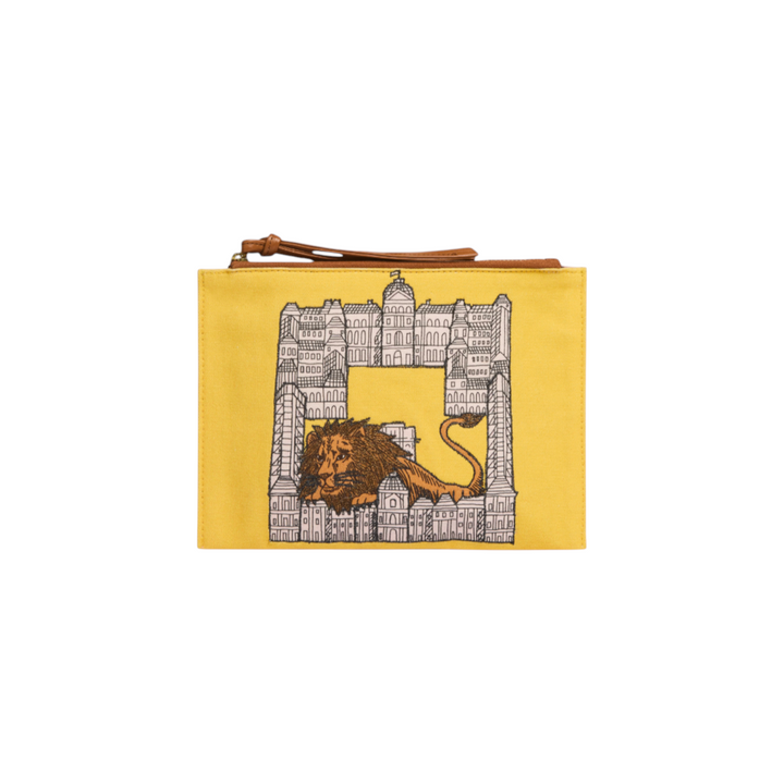 The Tiny Finch yellow cotton pouch featuring an embroidered lion and city building design with brown leather trim.