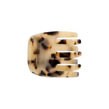 The Tiny Finch mini claw hair clip in blonde tortoise Italian bio-acetate with a secure grip for all hair types.