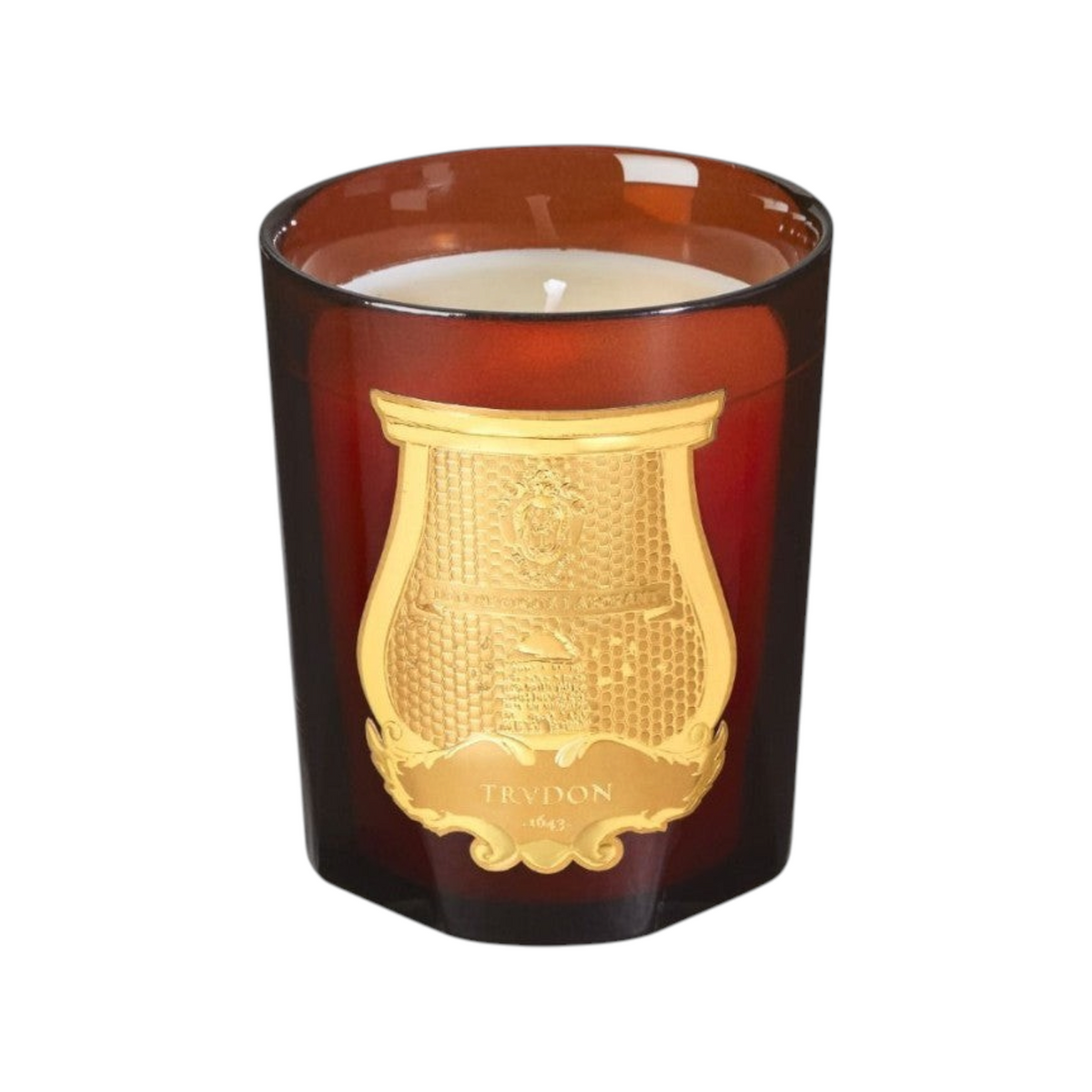 The Tiny Finch Cire scented candle in an amber glass vessel with a gold emblem and white wax, 270g.