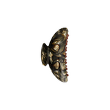 The Tiny Finch midi hair claw clip in midnight horn patterned Italian acetate with reinforced stainless steel teeth.