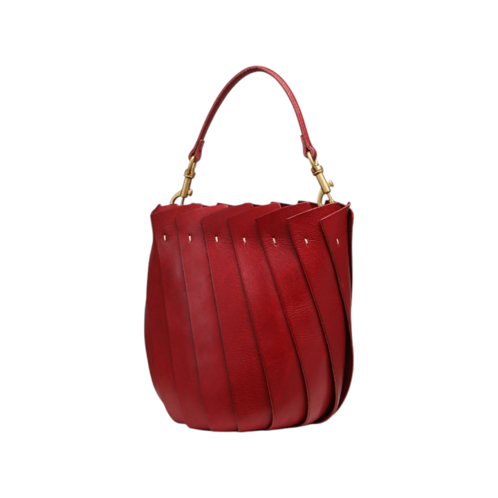 The Tiny Finch Bloom bucket tote in ruby red Italian leather with an organic tulip-inspired silhouette and brass hardware