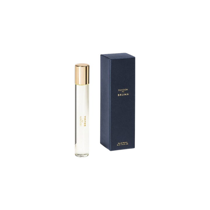 The Tiny Finch Bruma travel perfume spray bottle with gold cap next to its dark blue branded box.