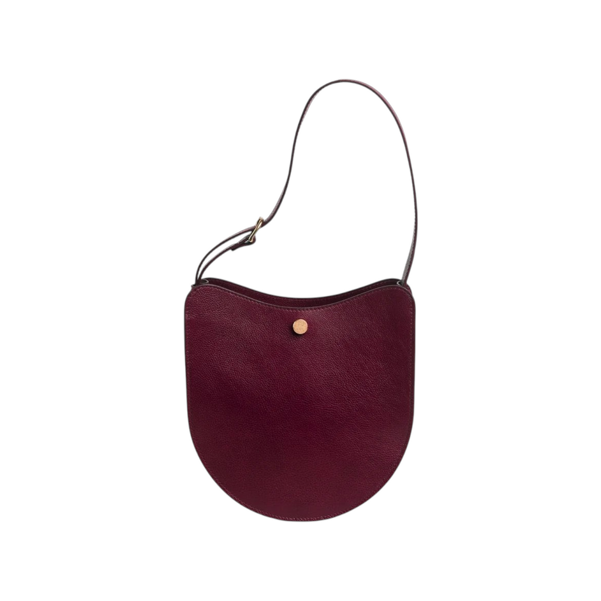 The Tiny Finch Savoie sumac red pebbled leather crossbody bag with brass hardware and adjustable shoulder strap.