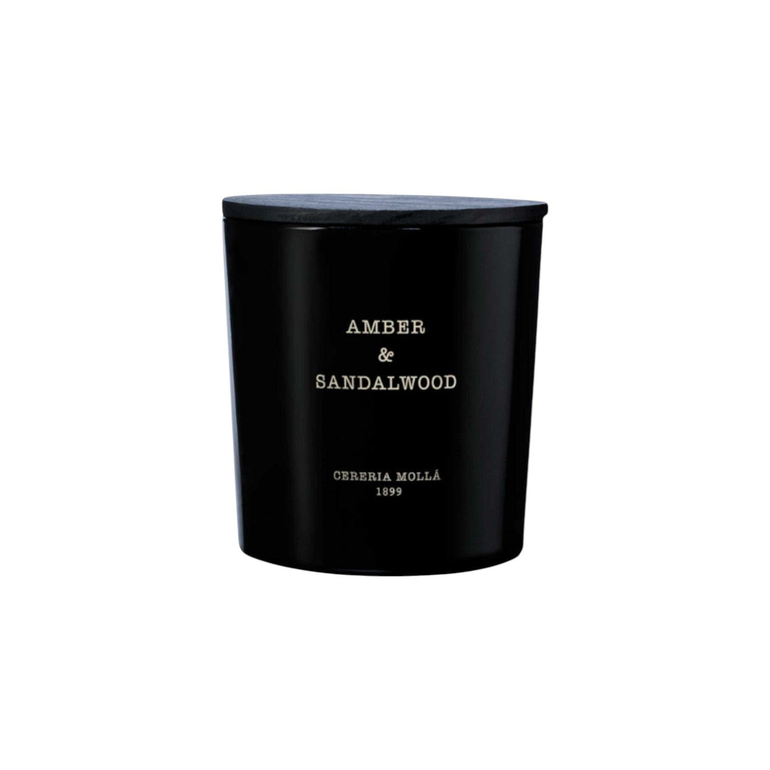 The Tiny Finch Amber & Sandalwood 3-wick candle in a black hand-painted glass vase with a matching wooden lid.