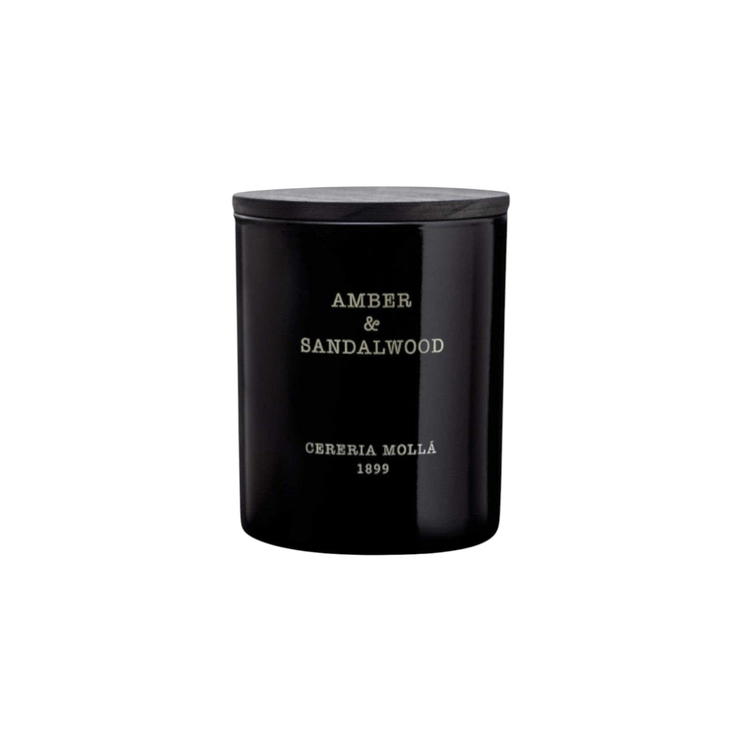 The Tiny Finch Amber & Sandalwood scented candle in a black hand-painted glass vase with a wooden lid.
