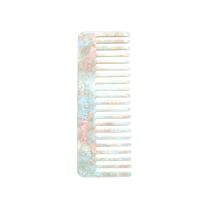 The Tiny Finch wide-tooth comb in Astral Mint, handcrafted from marbled Italian acetate for all hair types.