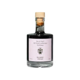 The Tiny Finch barrel-aged balsamic vinegar in a glass bottle with a wooden cork stopper and minimalist label.