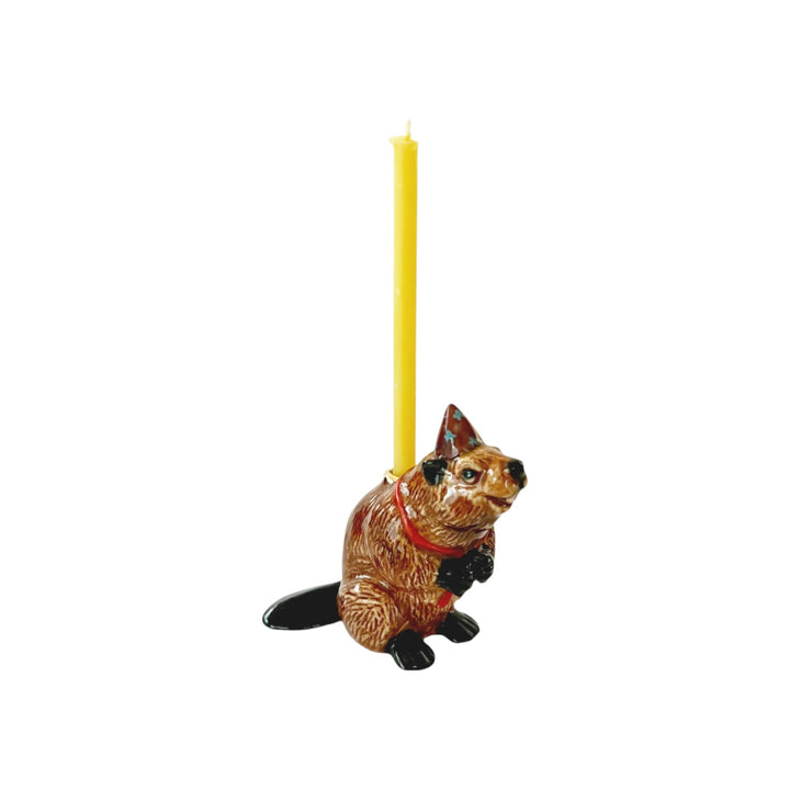 The Tiny Finch porcelain beaver cake topper with a party hat and yellow birthday candle holder