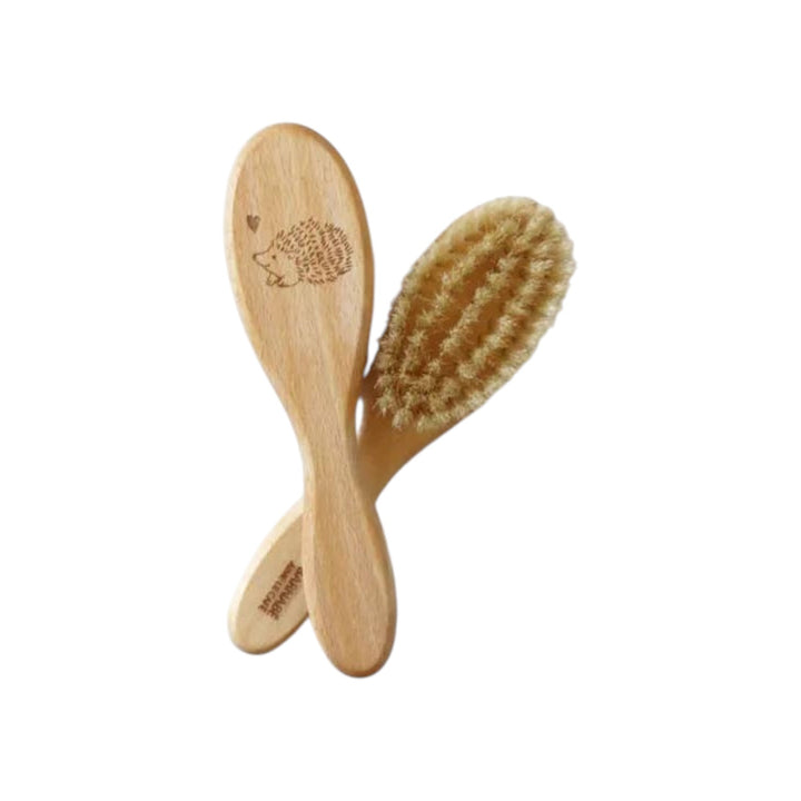The Tiny Finch baby hairbrush made of beech wood with soft white silk bristles and a cute hedgehog engraving.