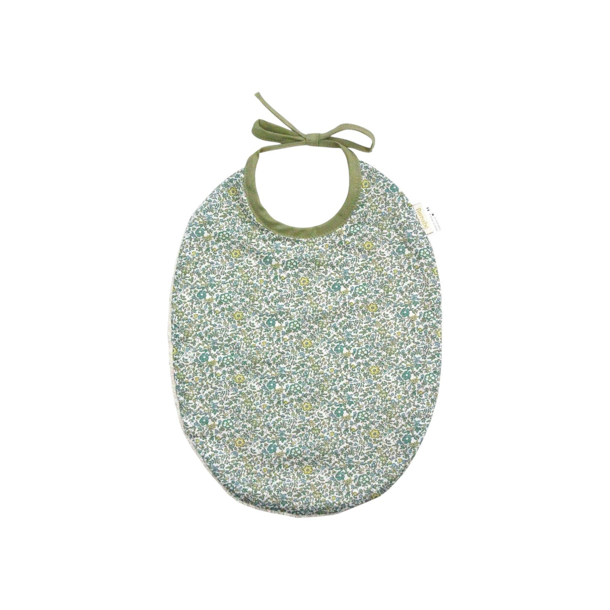 The Tiny Finch Bib Andréa featuring a green Liberty floral cotton print on one side and absorbent sponge on the back.