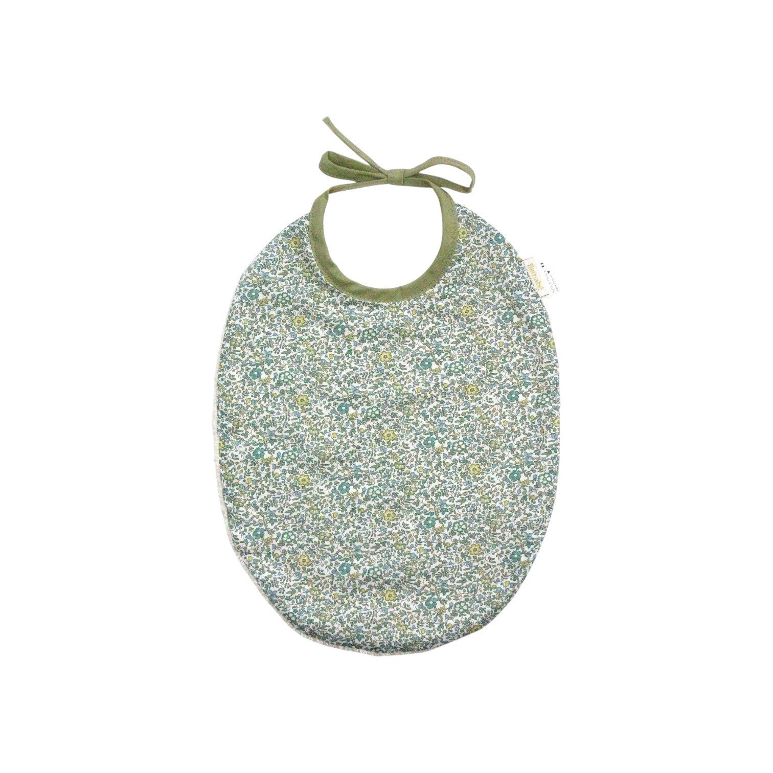 The Tiny Finch Bib Andréa featuring a green Liberty floral cotton print on one side and absorbent sponge on the back.