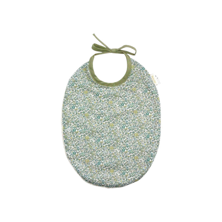 The Tiny Finch Bib Andréa featuring a green Liberty floral cotton print on one side and absorbent sponge on the back.