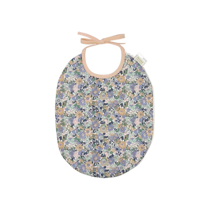 The Tiny Finch Bib Jenny featuring a floral Liberty fabric print with a soft sponge backing and tie closure.