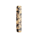 The Tiny Finch blonde tortoise wide-tooth travel comb handcrafted from Italian bio-acetate for all hair types.