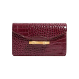 The Tiny Finch Pamela Munson Jackie Bag in bordeaux croc-embossed leather with a bamboo closure front view