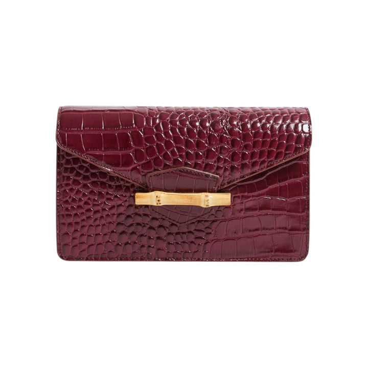 The Tiny Finch Pamela Munson Jackie Bag in bordeaux croc-embossed leather with a bamboo closure front view