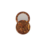 The Tiny Finch bronze circle pocket mirror with a swivel opening, crafted from marbled Italian acetate.