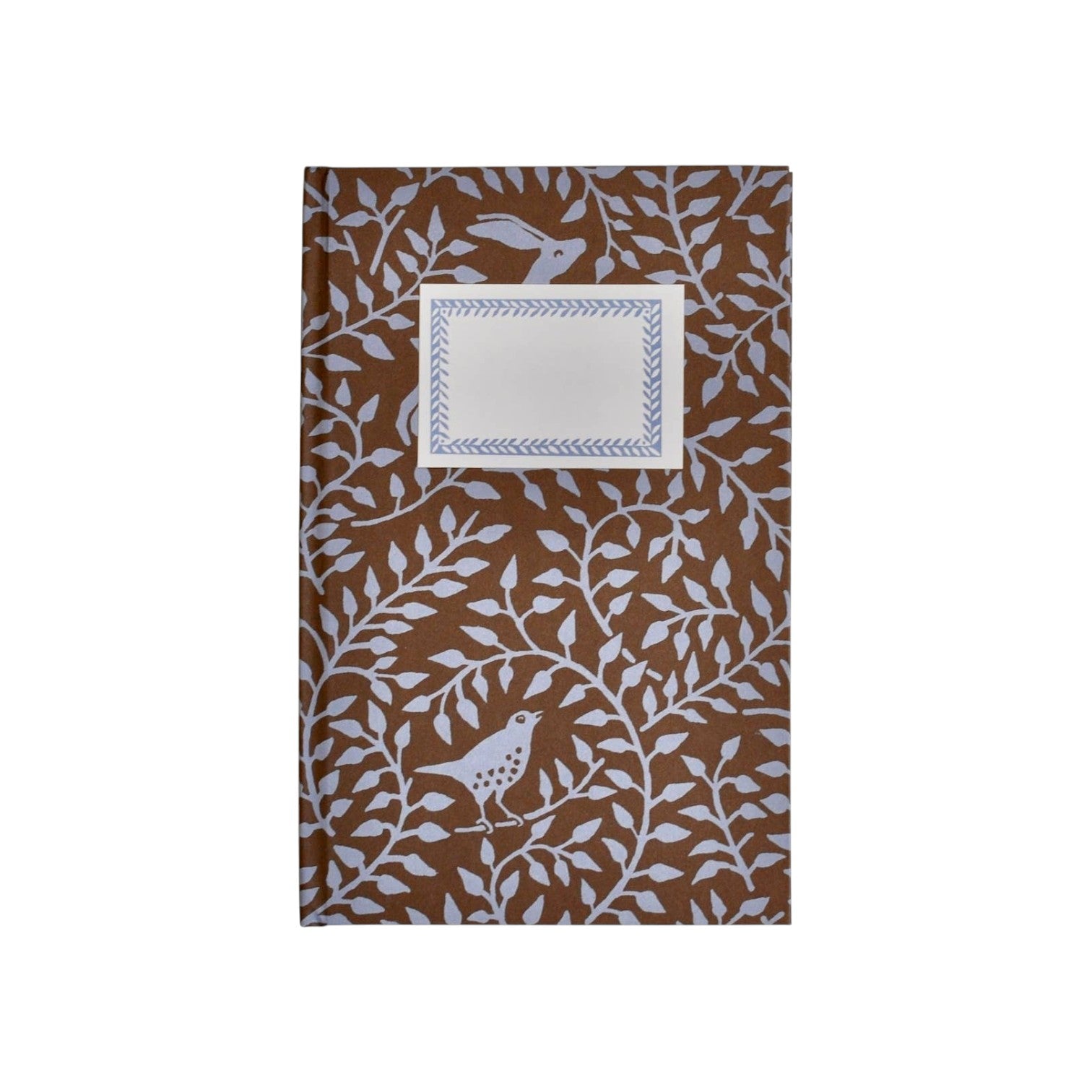 The Tiny Finch hardback notebook in bronze with a dancing hare and bird pattern and a rectangular cream label.