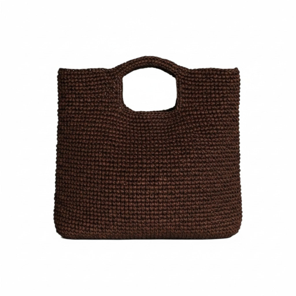 The Tiny Finch brown raffia Marina bag with a square shape and cutout handles, featuring an interior leather base.