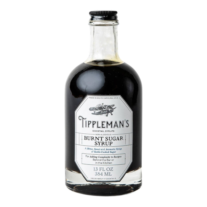 The Tiny Finch Tippleman's Burnt Sugar cocktail syrup in a clear glass bottle with a white label.
