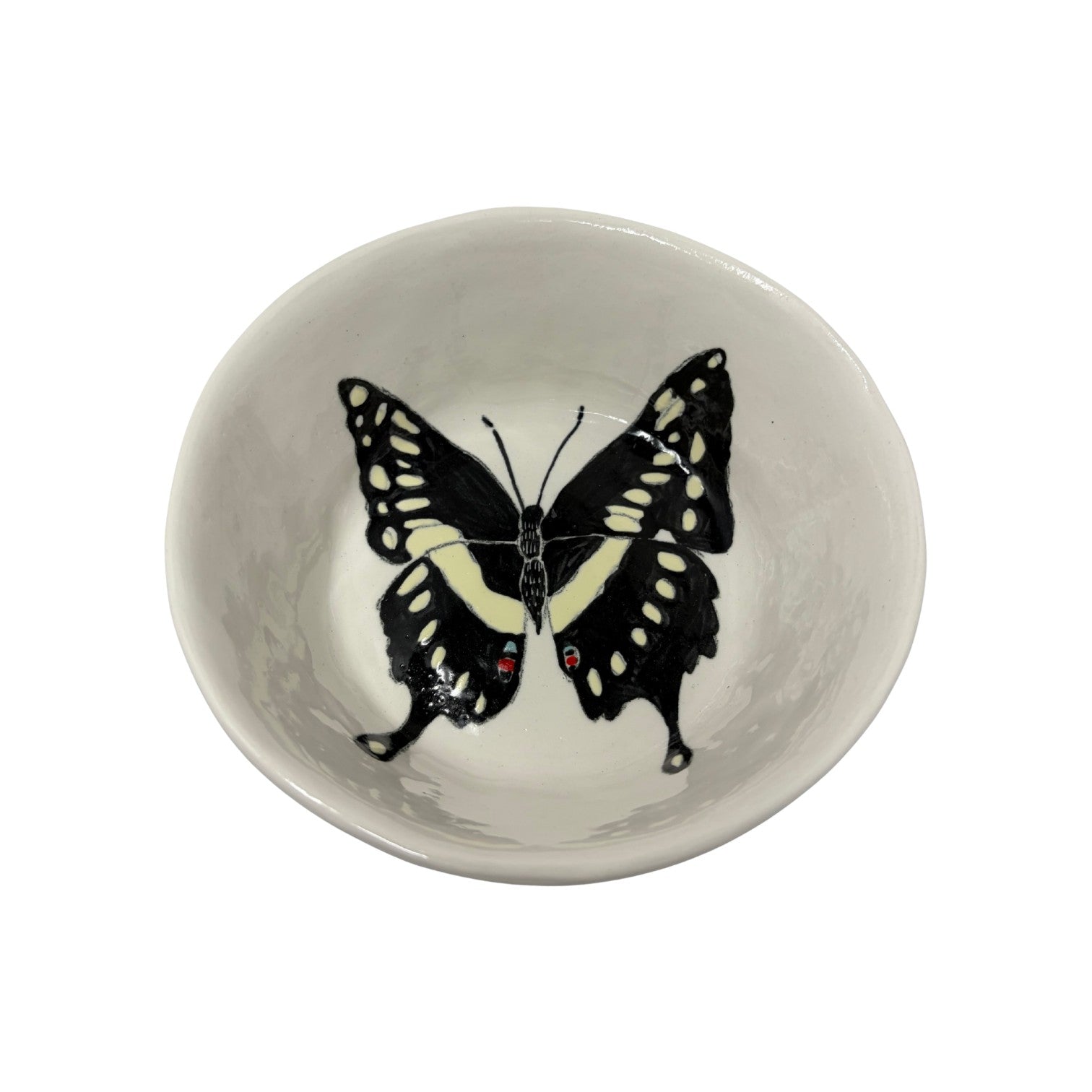 The Tiny Finch ceramic snack bowl featuring a hand-painted black and yellow butterfly design on a white background.