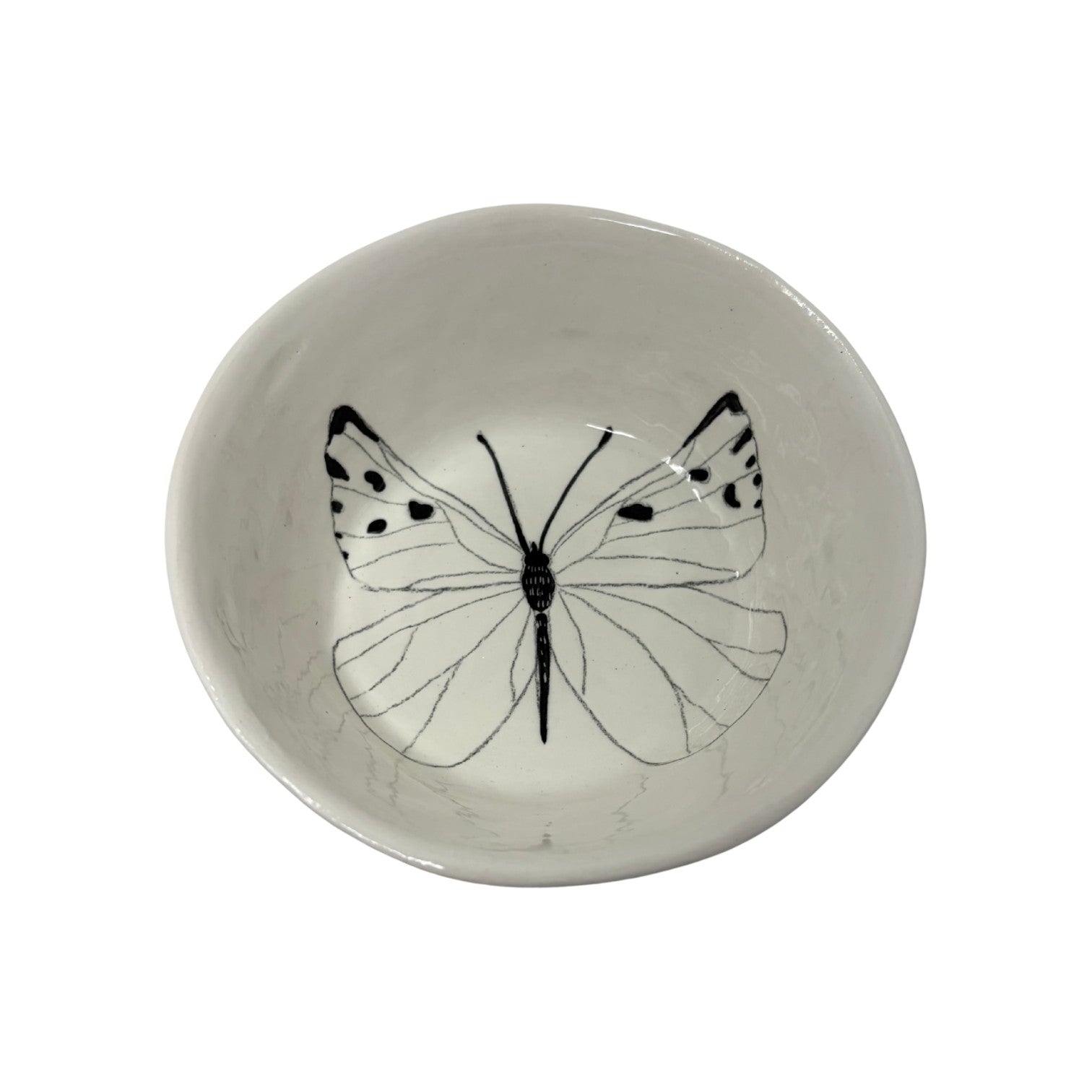 The Tiny Finch white ceramic snack bowl featuring a delicate black butterfly illustration on the interior base.
