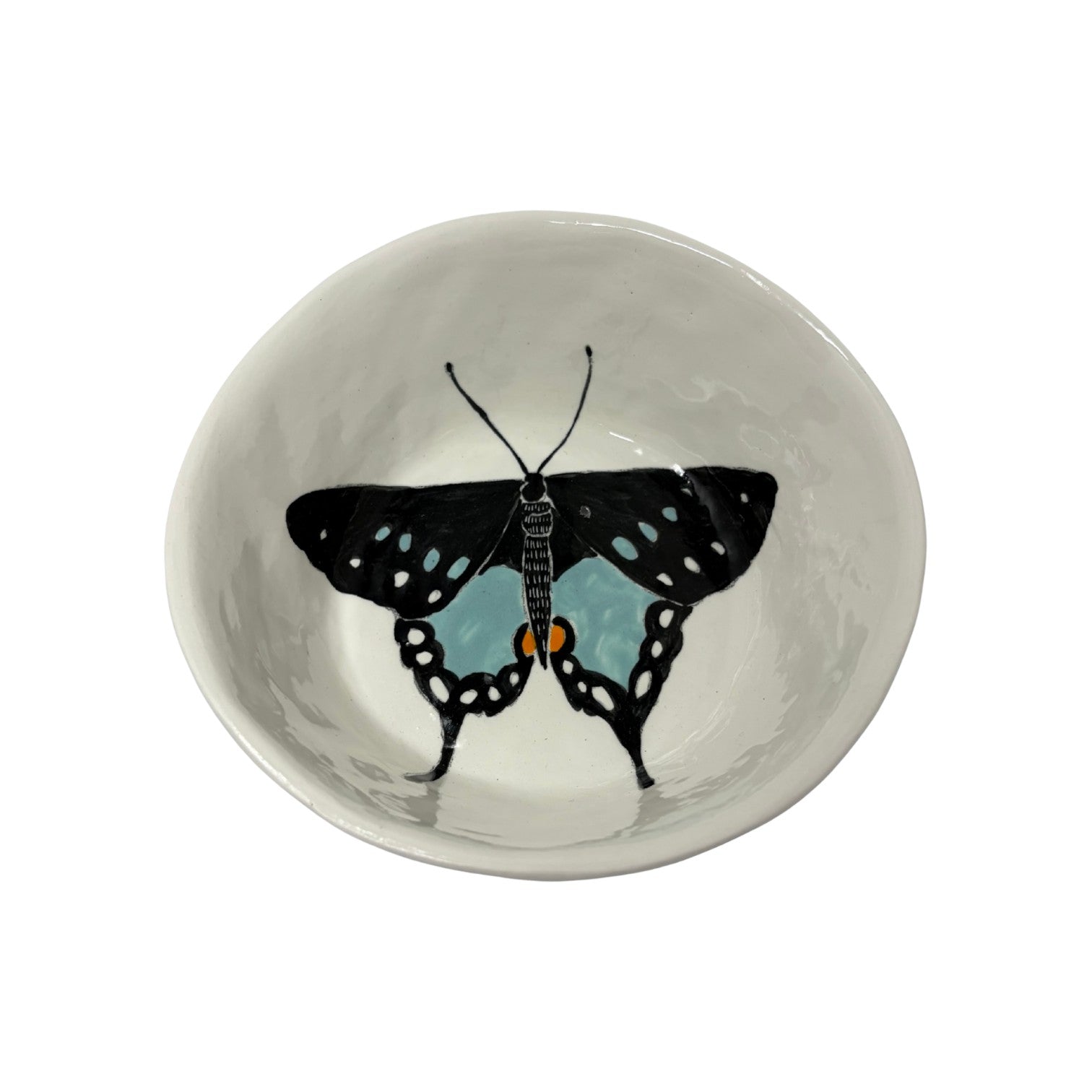 The Tiny Finch ceramic snack bowl featuring a hand-painted black and blue butterfly design on a white background.