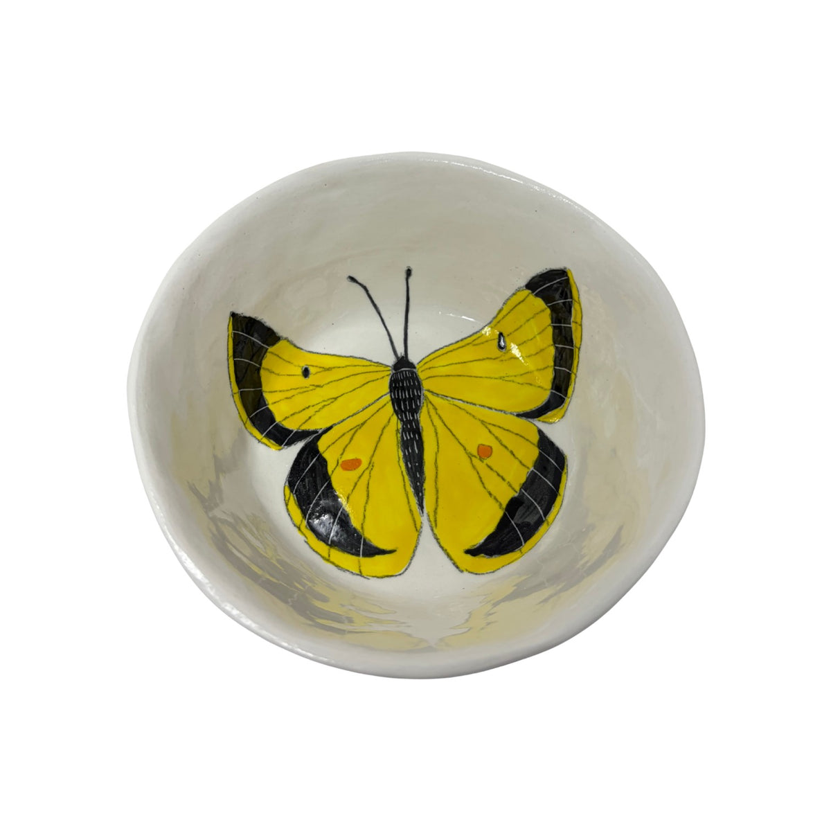 The Tiny Finch ceramic snack bowl featuring a hand-painted yellow and black butterfly design on a white background.