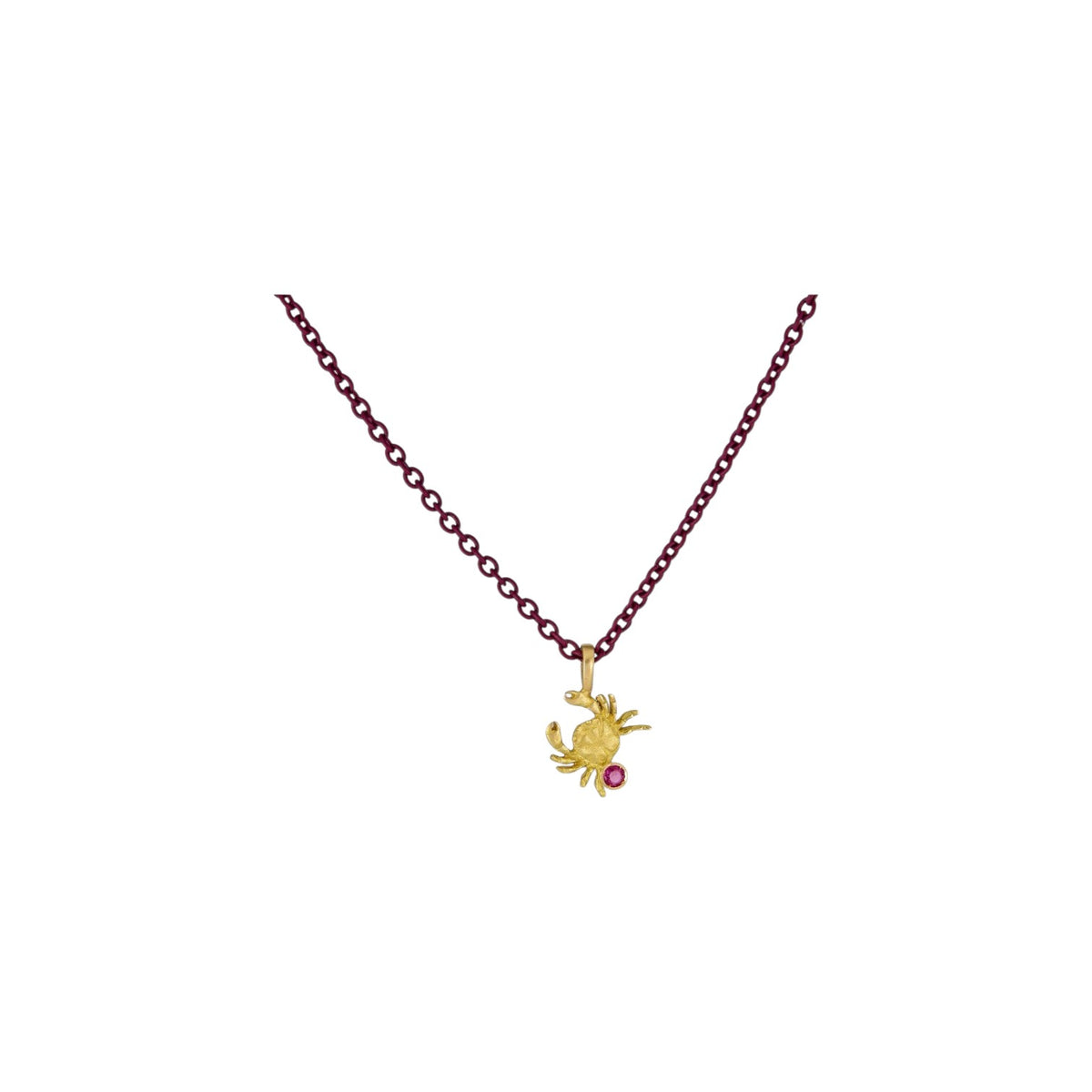 The Tiny Finch 18k yellow gold Cancer zodiac pendant with a ruby accent and satin finish on a dark chain.