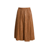 The Tiny Finch Claudia midi skirt in chestnut faux leather with an elastic waist and side seam pockets.