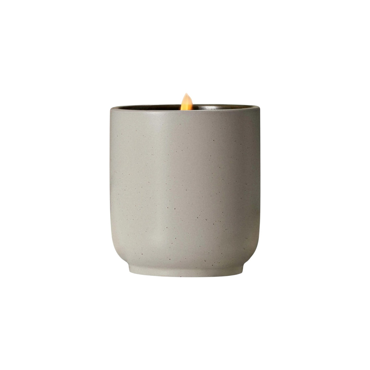 The Tiny Finch Cocomoi soy wax candle in a speckled grey kiln-fired ceramic vessel with a lit organic cotton wick.