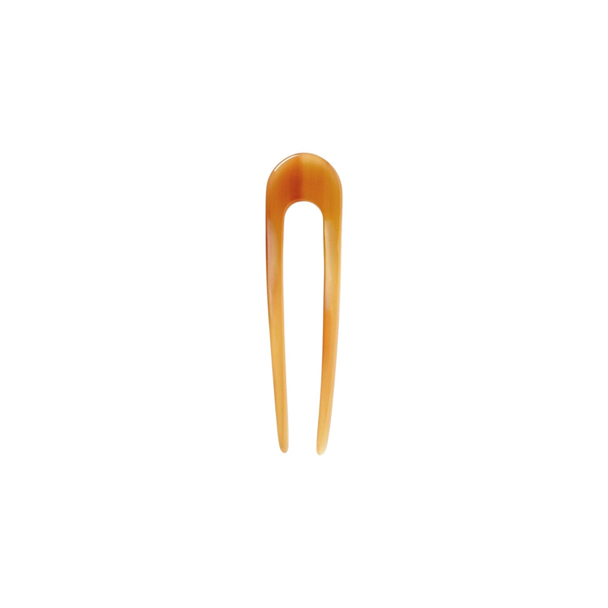 The Tiny Finch French hair pin in cognac brown, handcrafted from smooth Italian acetate for all hair textures.