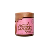 The Tiny Finch Coop's Salted Caramel sauce in a 10 oz jar with caramel dripping down the side and a pink label.