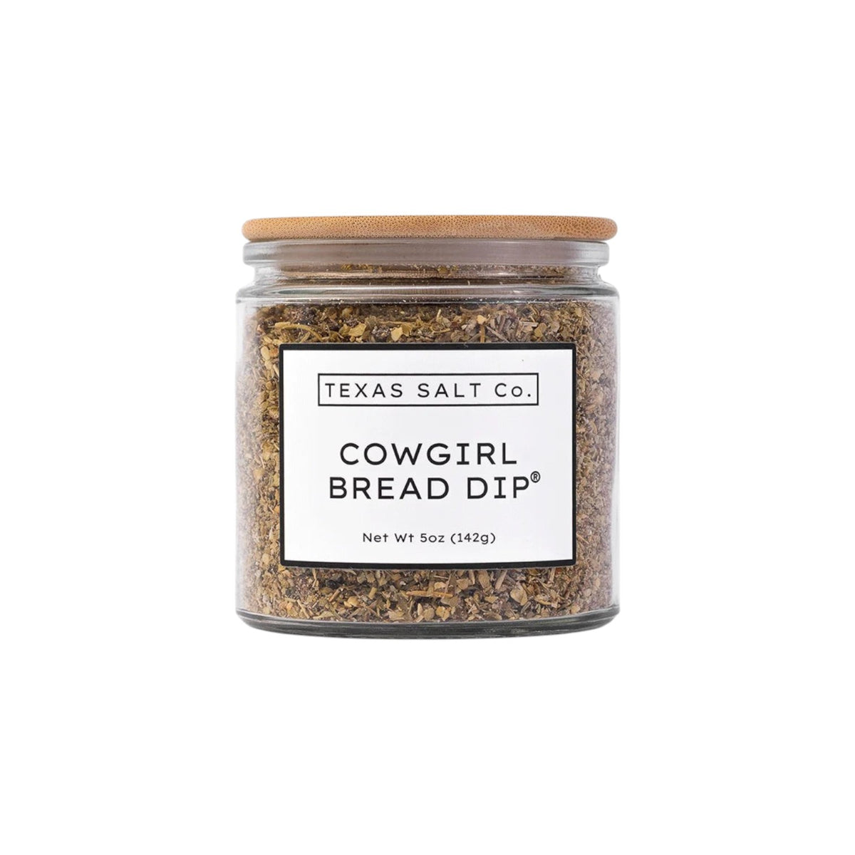 The Tiny Finch Cowgirl Bread Dip seasoning mix in a glass jar with a bamboo lid, featuring sun-dried tomato and herbs.