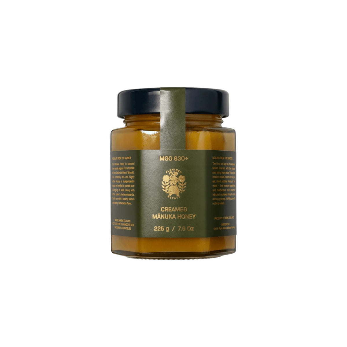 The Tiny Finch Flamingo Estate creamed Manuka honey in a glass jar with a dark green label and black lid.